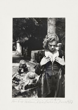 Helmut Newton, Père Lachaise, Tomb of Talma, Paris 1977 © Helmut Newton Foundation, Courtesy Nicola Erni Collection. Annotation: “Yves St.Laurent’s corset, my raincoat, by the Tomb of Talma, Père Lachaise, Paris, 1977”